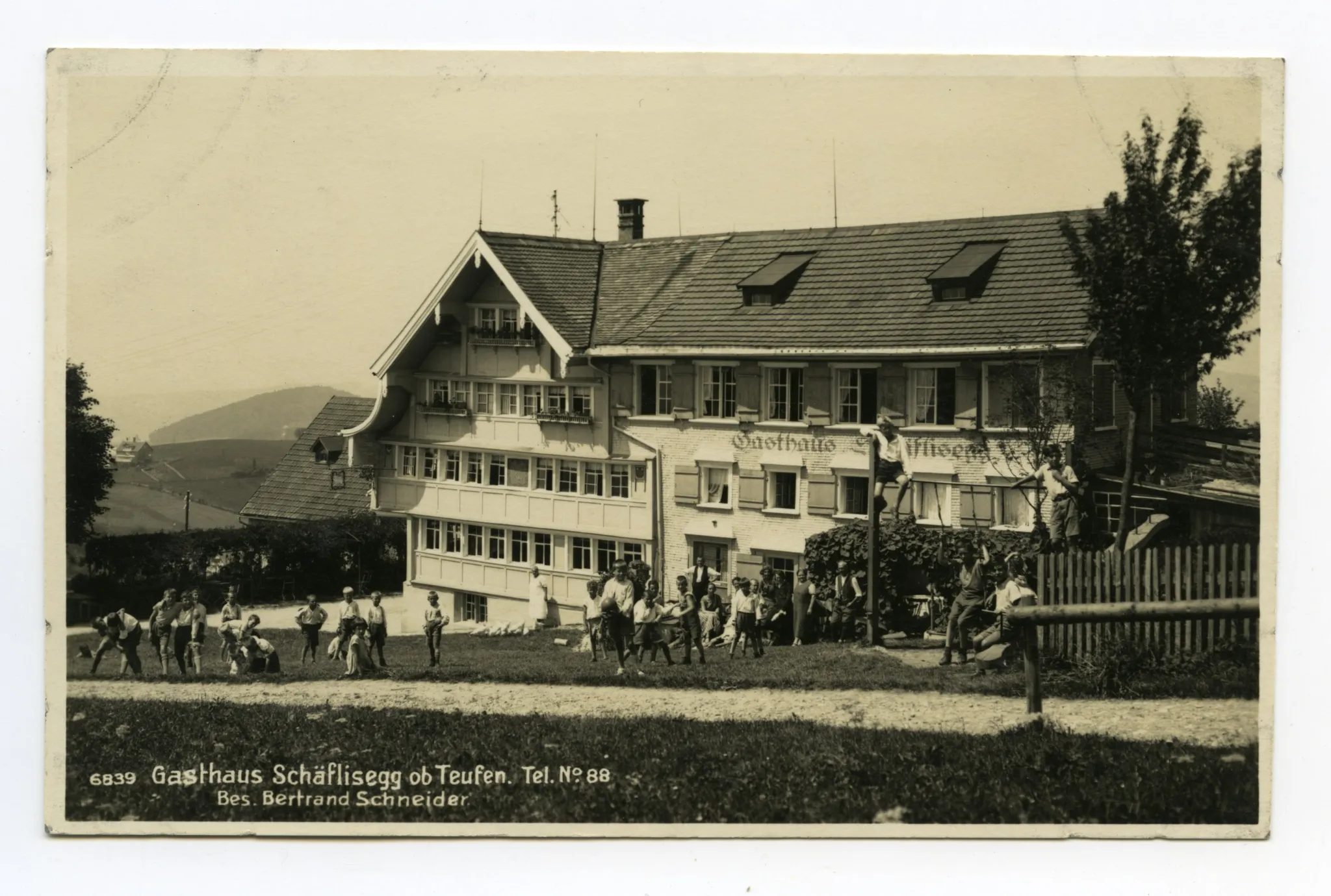 Aussenansicht aus Südosten mit vielen spielenden Kindern (Schulklasse?)