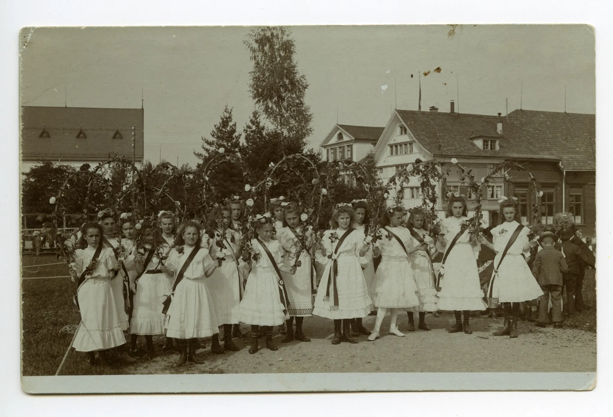 Mädchengruppe in weissen Kleidern und Blumenbögen auf dem Zeughausplatz, alte kath. Kirche abgeschnitten