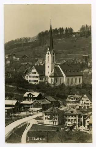 Vorne: Quartier Sammelbüel mit Areal Studach (z.T.), Hauptstrasse und Bahngleis mit Zahnstange